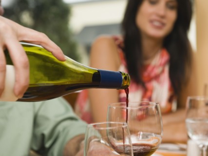 Waiter pouring wine in restaurant.