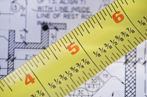 Close up of blueprint and tape measure. Photographe : Daniel Grill