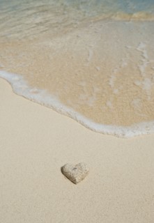 Heart shaped sand on beach.