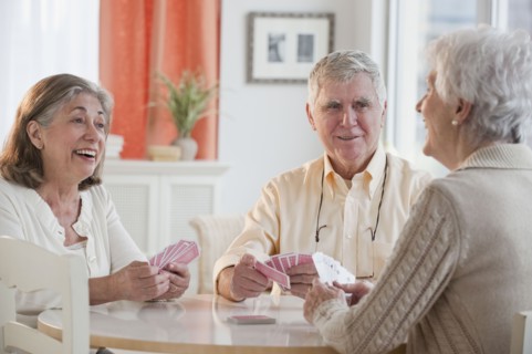 Senior adults playing cards.