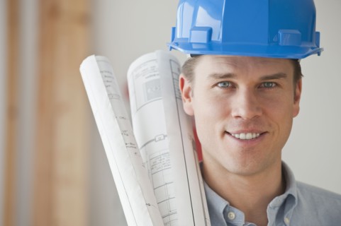 Architect holding blueprints.
