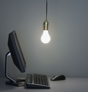 Light bulb hanging over computer.