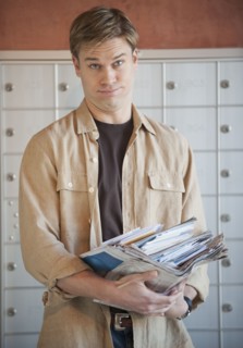 Man holding stack of mail.