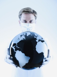 Scientist holding black and white globe.