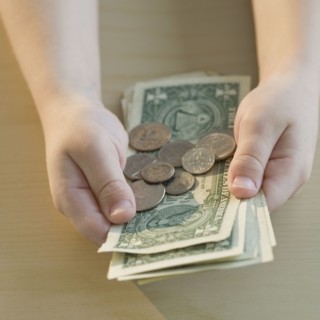 Boy holding money.