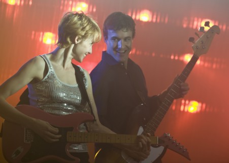 Performers playing electric guitars.