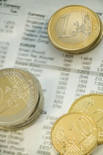 Stacks of euro coins and exchange rates.
