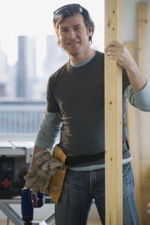 Construction worker holding board.