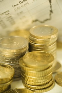 Stacks of euro coins and exchange rates.