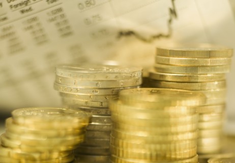 Stacks of euro coins and exchange rates.