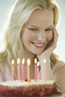 Woman celebrating birthday with cake.