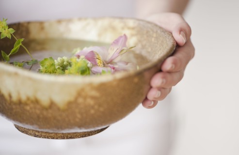 Woman holding aromatherapy bowl.