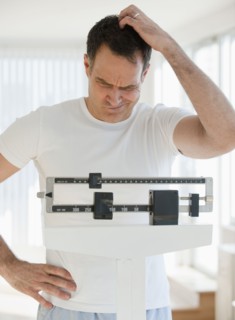 Mature man on scales.