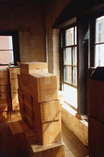 Stacked cardboard boxed in house. Photographe : Stewart Cohen