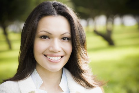 Portrait of woman smiling in park. Photographe : PT Images
