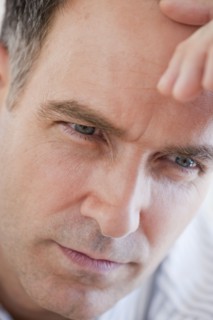 Mature businessman contemplating, close-up.