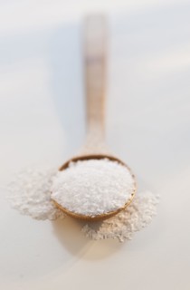 Wooden spoon of salt, studio shot.