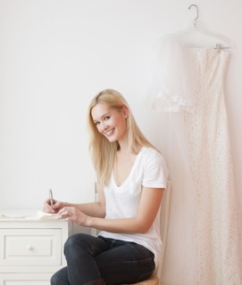 Portrait of young woman writing wedding invitation. Photographe : Jamie Grill