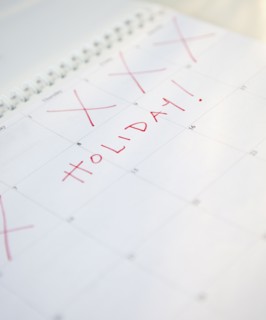 Close-up of holiday written on calendar. Photographe : Jamie Grill