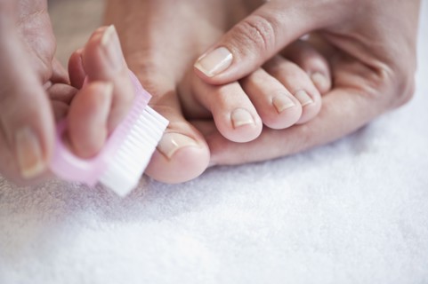 Woman caring for her toenails. Photographe : Daniel Grill