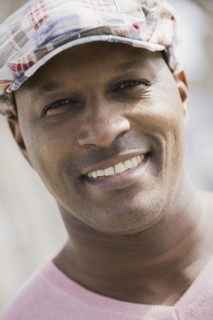 Portrait of man wearing cap, smiling. Photographe : PT Images