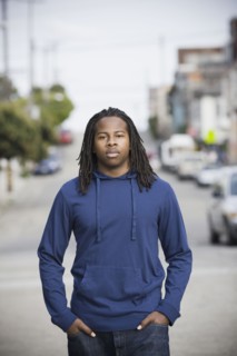 Portrait of teenage boy (16-17) walking in street, San Francisco, California, USA. Photographe : PT