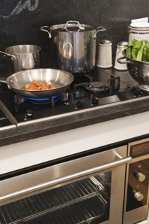 Vegetables in frying pan on cooker.
