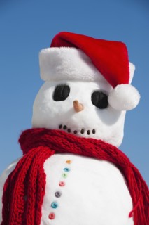 Snowman wearing Santa hat.