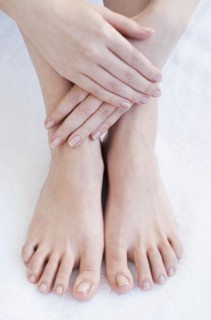 Close-up of woman's hands and feet.