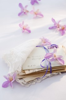 Old letters wrapped in handkerchief with flowers around.