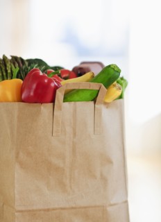 Paper bag filled with vegetables.