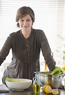 Woman preparing food in kitchen, portrait.