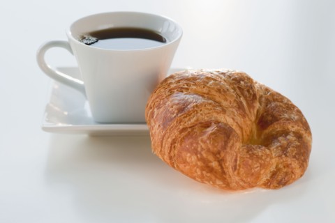 Studio shot of coffee and croissant.