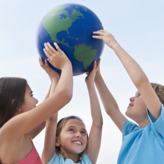 Children holding a globe.