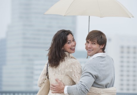A couple outdoors in the rain.