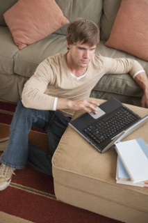 Man using laptop in living room.