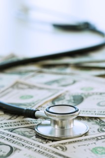Stethoscope on bank notes