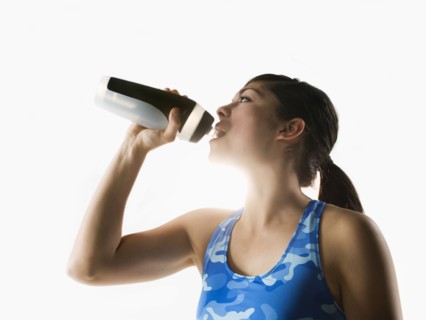 Woman drinking water while training
