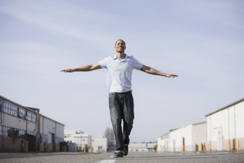 A man walking the line on a road