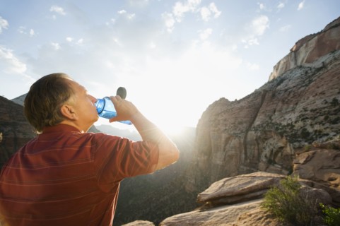 A man drinking water at Red Rock