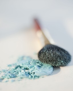 Powder beside a make up brush