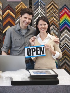 A woman and man at a frame store.