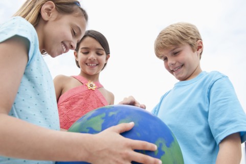 Children holding a globe.