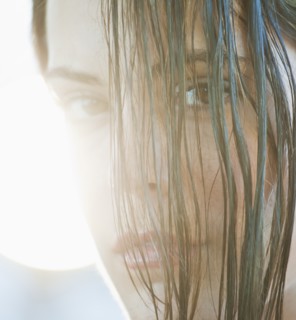 A woman outdoors with hair in her eyes