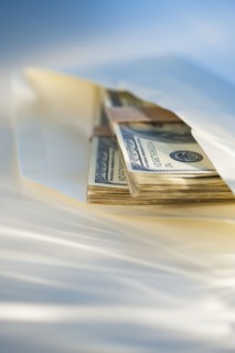 Hundred dollar bills in an envelope