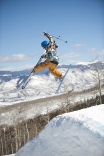 A downhill skier jumping