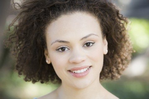 A woman outdoors smiling