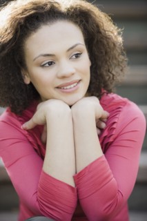 A woman outdoors on stairs smiling