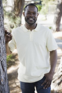 A man outdoors by some trees