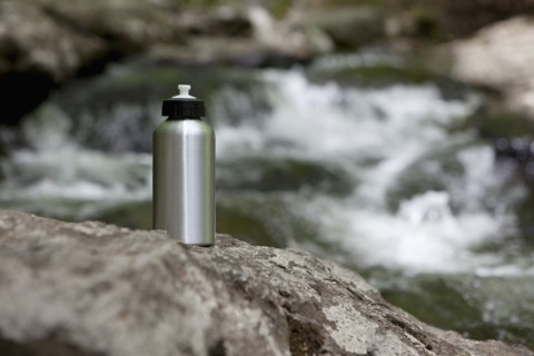 A reusable water bottle in the woods